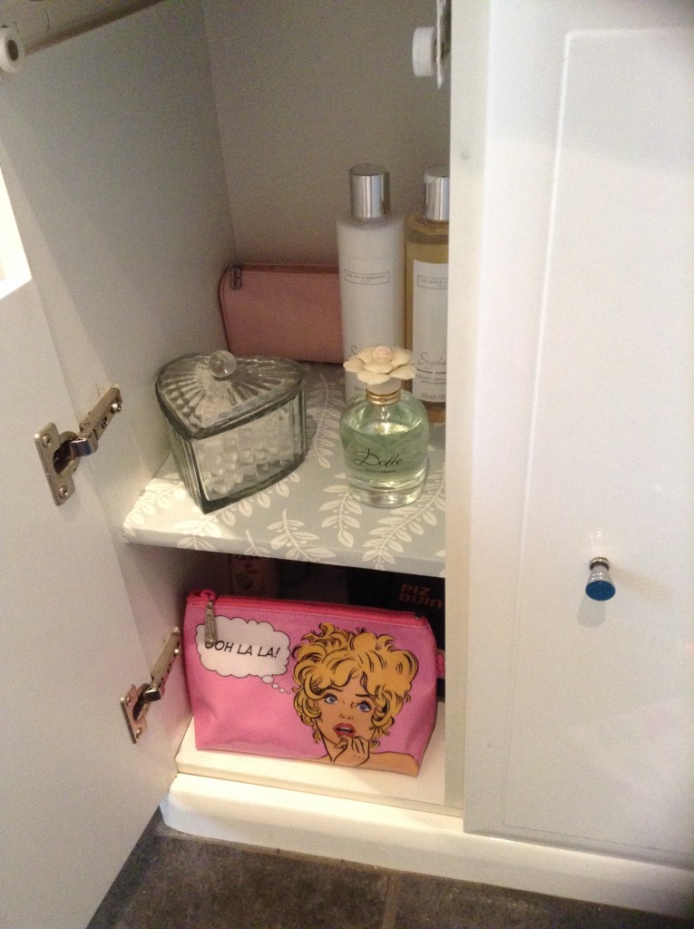 lining a bathroom cabinet with wallpaper