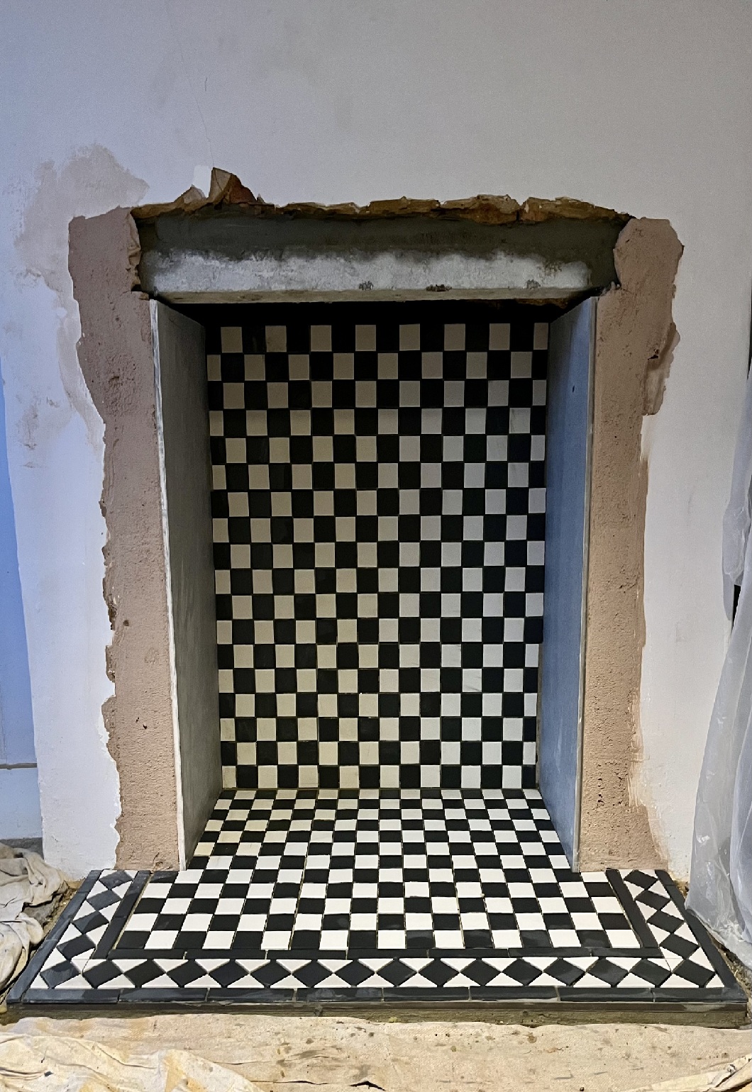 Black and white checkerboard tiles fireplace